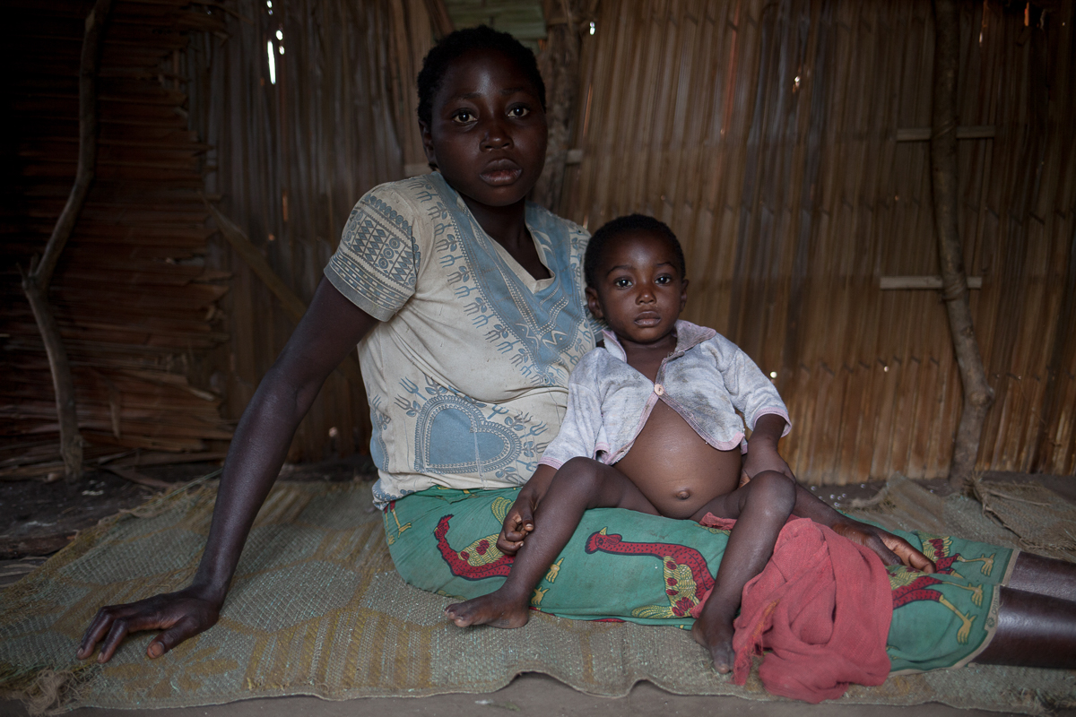Pauline Patou, holds her 9 months old child Marlin Nganke, that suffers from diarrhea ever since the two days they spent hiding in the forest, as the "Siriri" attacked their village, a month ago. Now