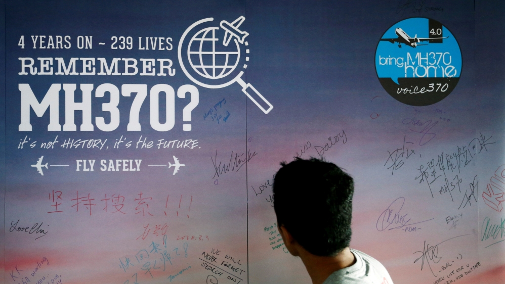 Man looks at message board for passengers onboard missing MH370 in Kuala Lumpur