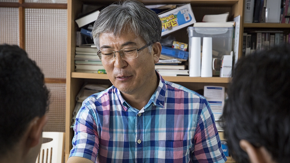 Lee Jung Hoon is a Korean pastor who has given shelter to five Yemenis. In addition, he also teaches them Korean language so they can find better jobs if the government allows [Faras Ghani/Al Jazeera]