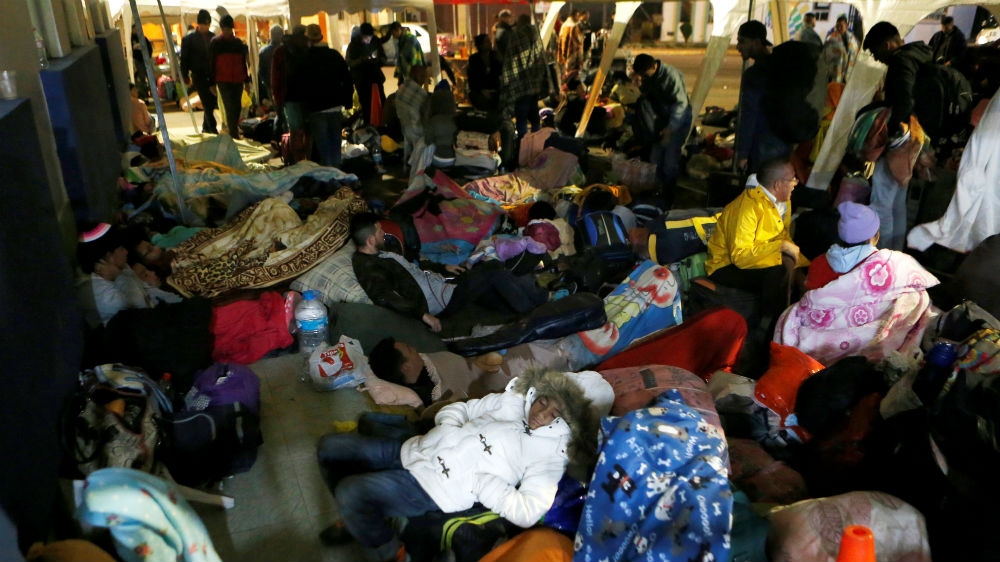 Venezuelan migrants take refuge inside a tent at the Rumichaca International Bridge [Luisa Gonzalez/Reuters] 