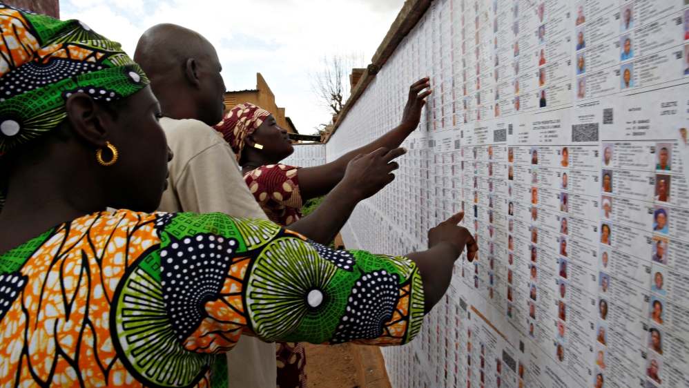 People prepare a polling station before the polls open for the presidential election in Bamako