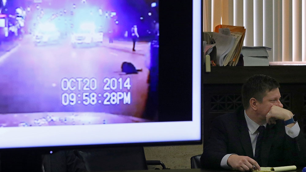 Chicago police Officer Jason Van Dyke looks on during his murder trial as a monitor displays a scene from a police vehicle dash cam video, moments after the shooting death of Laquan McDonald [File: John J Kim/Chicago Tribune/Reuters] 