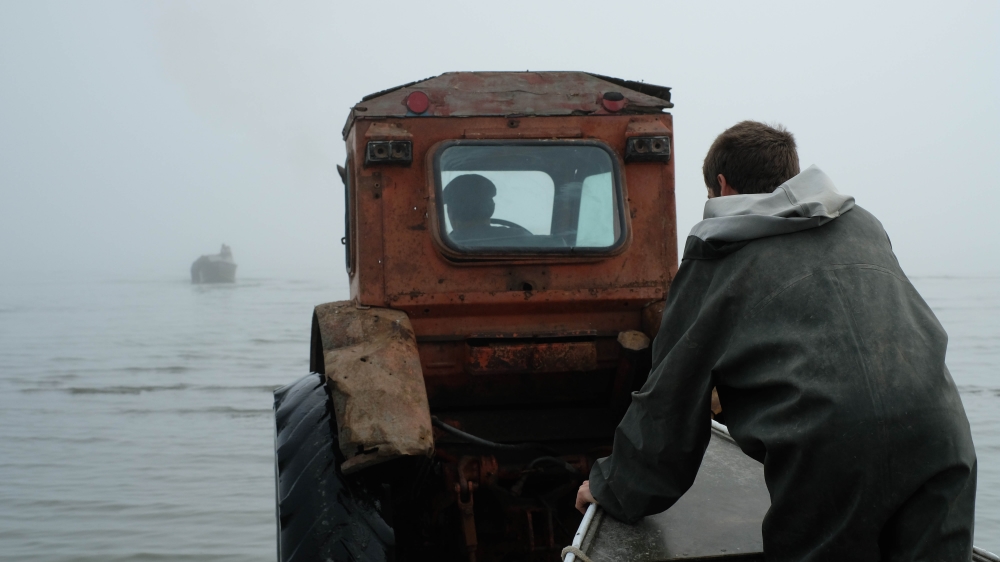 A boat being towed to sea by a specialised tractor [Nikolay Korzhov/Al Jazeera]