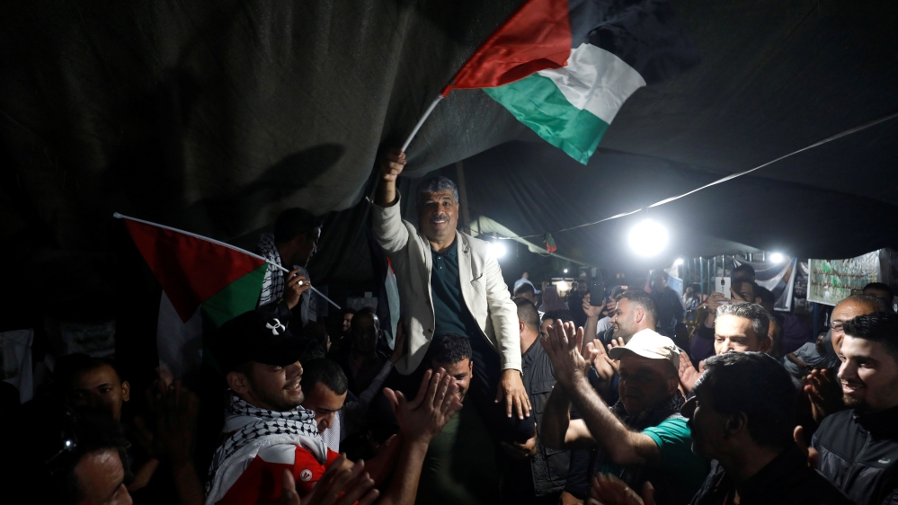 People celebrate inside the Palestinian Bedouin village of Khan al-Ahmar that Israel plans to demolish, in the occupied West Bank