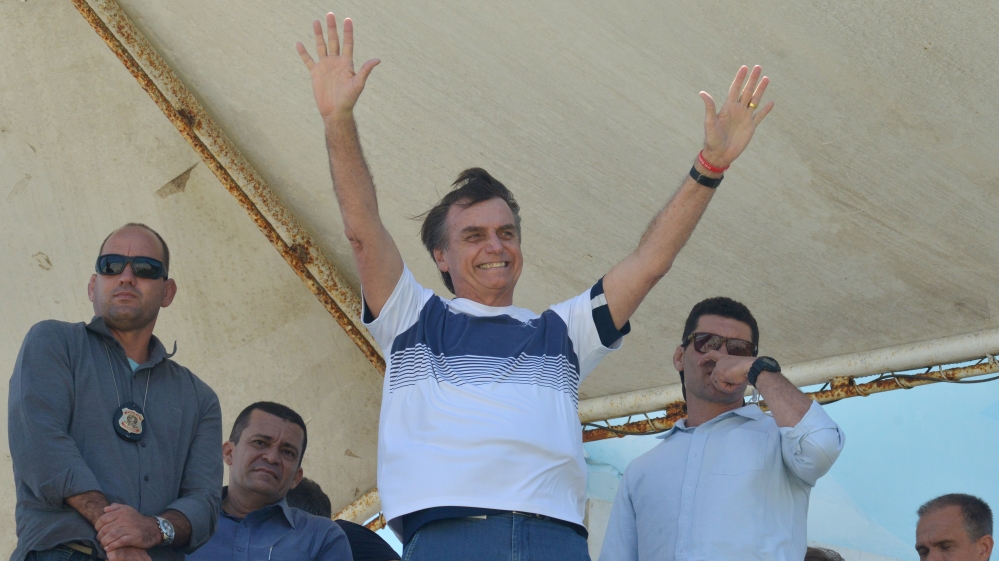 Brazil''s new president-elect, Jair Bolsonaro, waves to supporters as he watches airplanes performing near his condominium at Barra da Tijuca neighbourhood in Rio de Janeiro