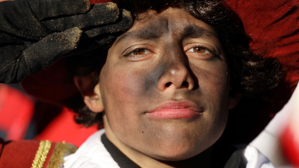 Black Pete is Saint Nicholas' assistant. Some recent participants smudged colour rather than wearing full blackface [Eva Plevier/Reuters]