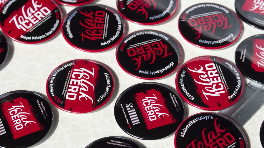 Makeshift stalls sold t-shirts and memorabilia for protesters. The badges read 'reject ICERD' and 'Save Malaysia' [Kate Mayberry/Al Jazeera]