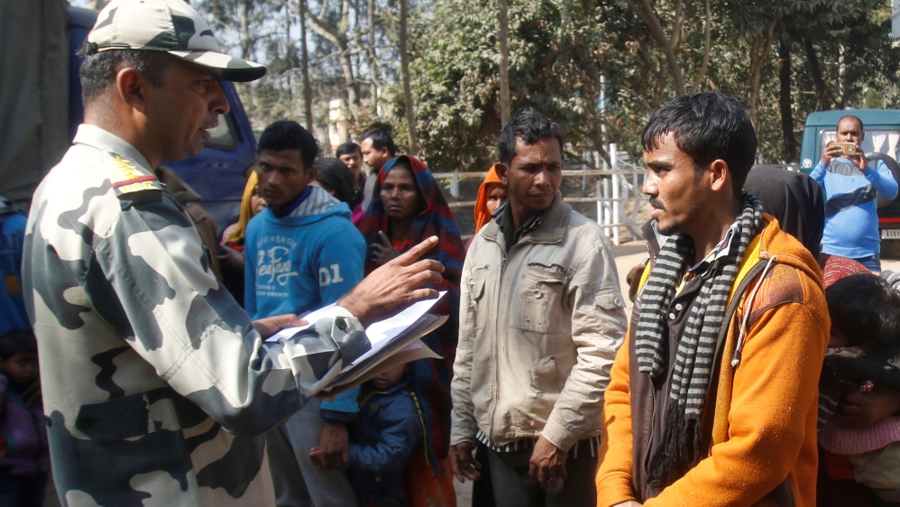 A BSF official registers the names of the Rohingya after they were detained on the outskirts of Agartala [Jayanta Dey/Reuters]