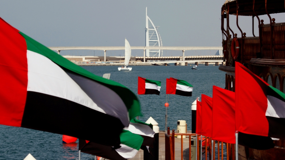 UAE flags fly as the Burj al-Arab luxury hotel is seen in the background during the UAE''s National Day in Dubai