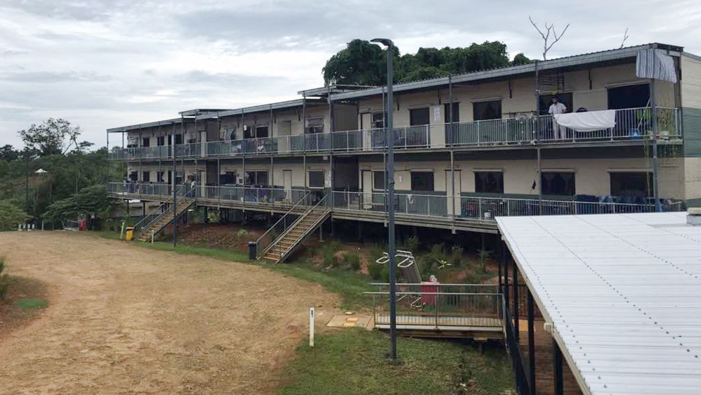 In this July 17, 2018, photo provided by Aziz Abdul, a man standing on a balcony at the East Lorengau Refugee Transit Center on Manus Island, Papua New Guinea.