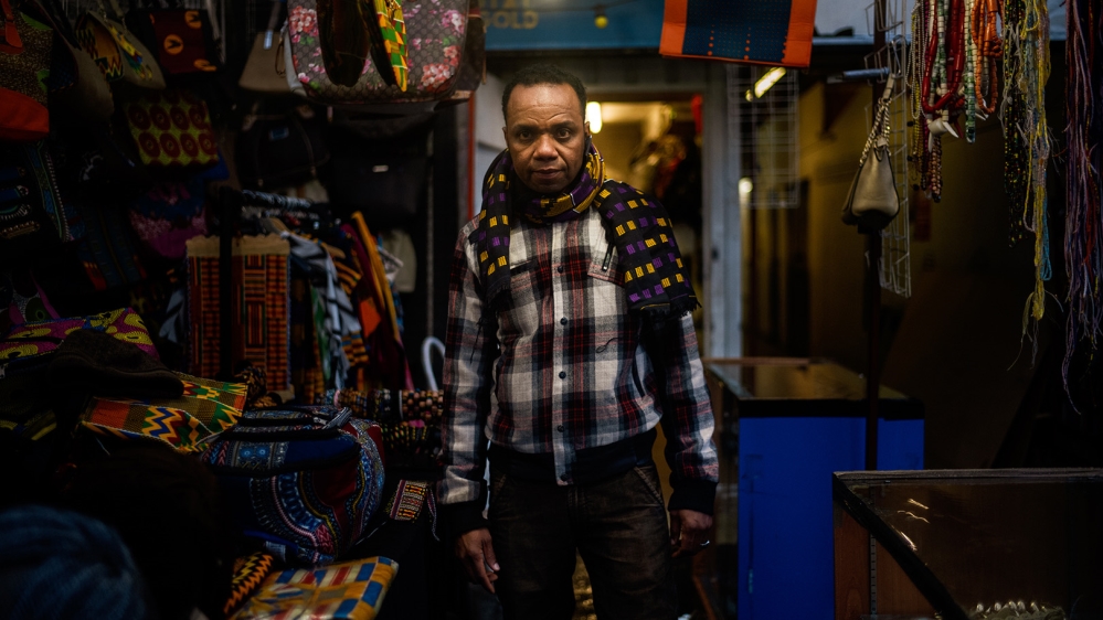 Mohammed Barry, a 51-year-old market trader, was nearly evicted from his store and says his business has suffered since [Jose Sarmento Matos/Al Jazeera]