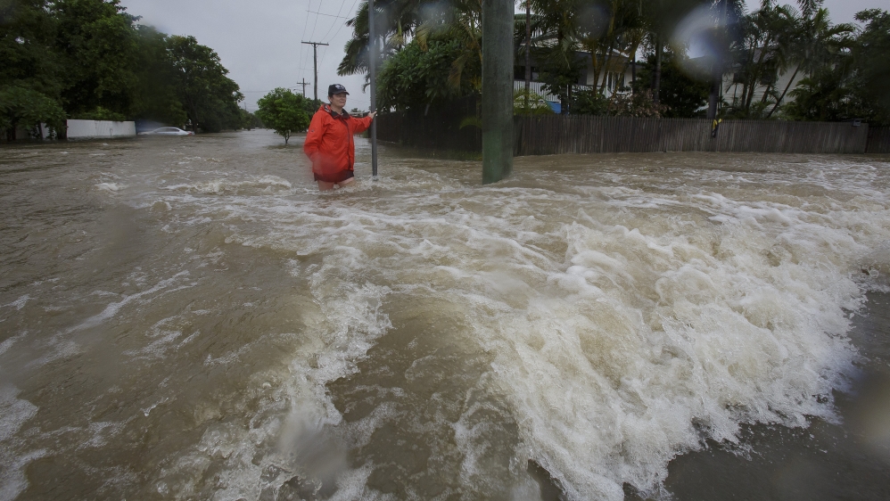 Amelia Rankin stands in flooded waters in Hermit Park, Townsville, Queensland, Australia