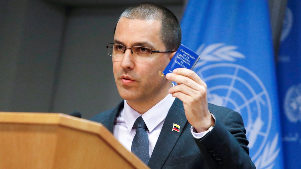 Venezuelan Minister of Foreign Affairs Jorge Arreaza displays a copy of the Constitution of Venezuela [Andrew Kelly/Reuters]