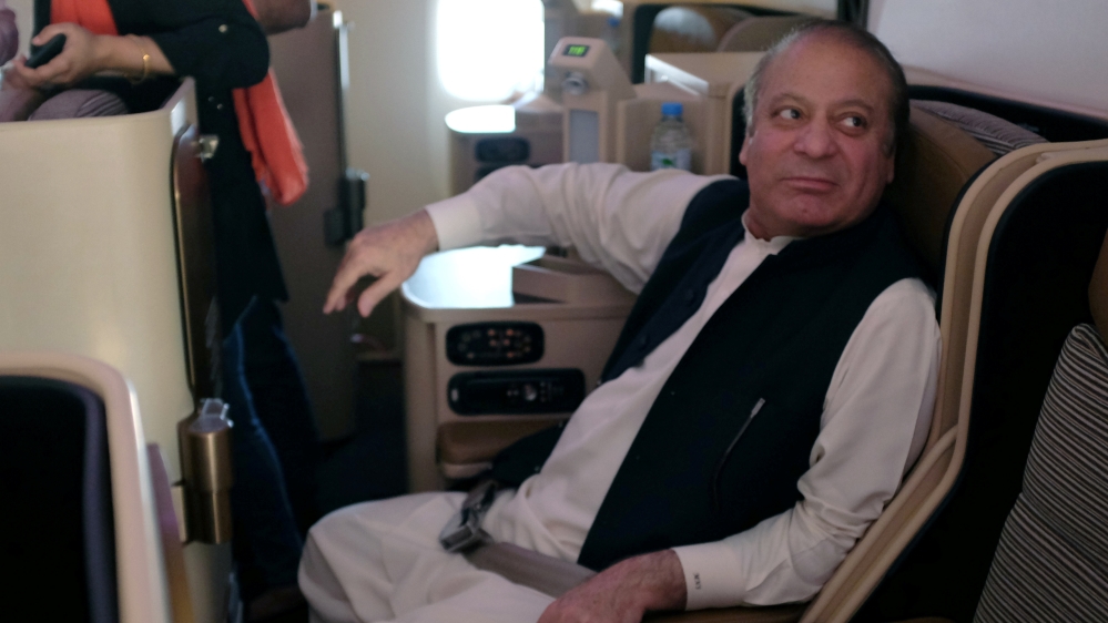 Ousted Pakistani Prime Minister Nawaz Sharif sits on a plane after landing at the Allama Iqbal International Airport