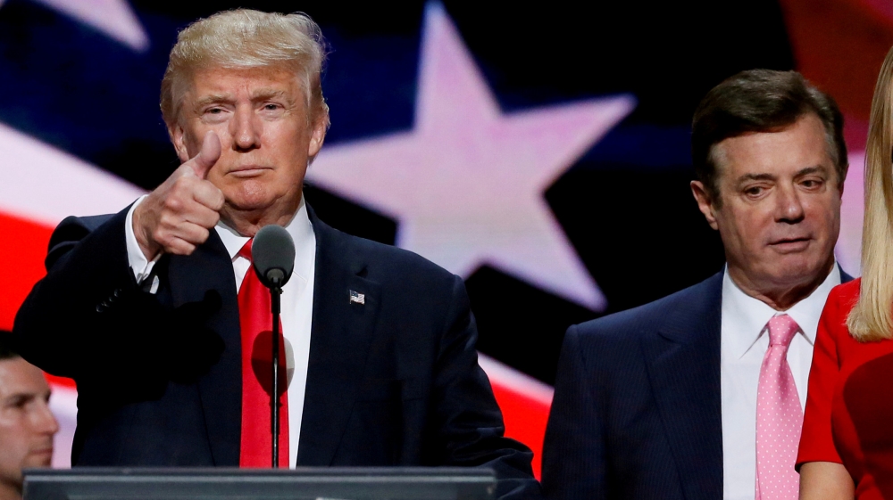 Then-Republican presidential nominee Donald Trump gives a thumbs up as his campaign manager Paul Manafort looks on during Trump's walk through at the Republican National Convention in Cleveland [File: Rick Wilking/Reuters]