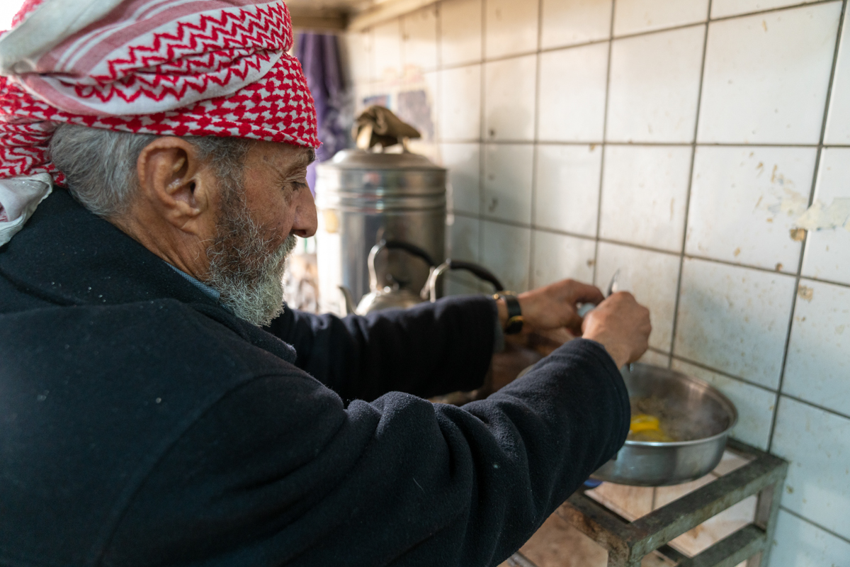 Qassim Yahya, 75 prepares breakfast inside a teashop in the Old City. He says that he''s seen hundreds of people beheaded or thrown off building by Islamic State fighters. [Emre Rende/Al jazeera]