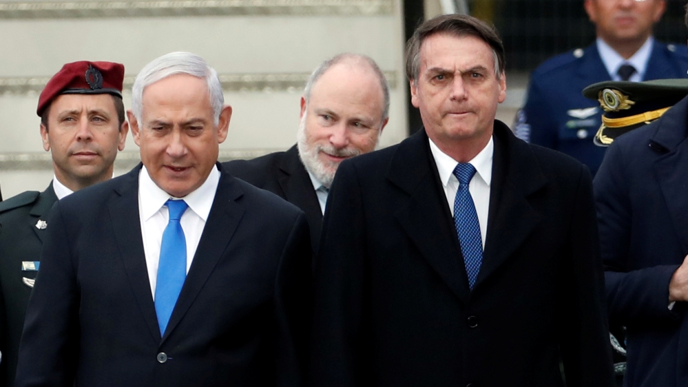 Brazilian President Jair Bolsonaro stands next to Israeli Prime Minister Benjamin Netanyahu during a welcoming ceremony upon his arrival in Israel