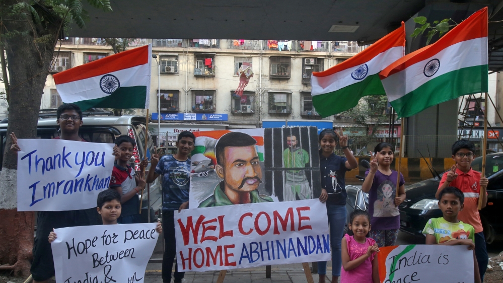 Children hold banners and Indian national flags after Pakistan''s PM Imran Khan said Pakistan will release an Indian Air Force pilot on Friday, in a street in Mumbai