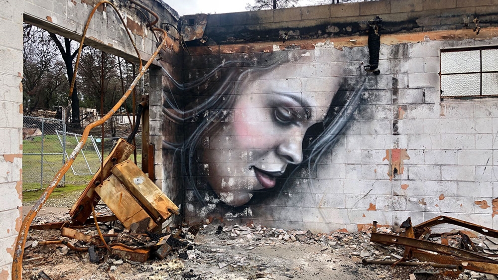 Tall chimneys and heaps of rubble are all that remain where homes once stood [Dena Takruri/Al Jazeera]