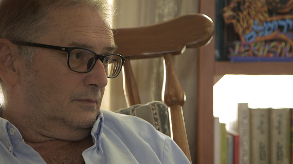 Meir Margalit, once a soldier in the Israeli army, reflects on the state of the city from his Jerusalem home [Al Jazeera]