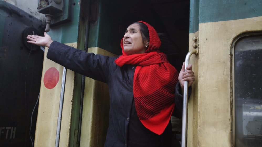 A passenger from India gestures to her relatives as she leaves by Samjhauta Express train which was temporarily suspended, at the railway station in Lahore,