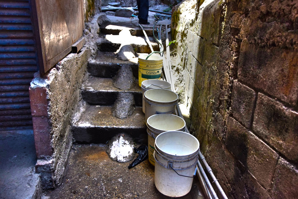 Faced with uncertainty of when water supply may return, people are conserving as much water as they can take when they find it available  [Elizabeth Melimopoulos/ Al Jazeera]