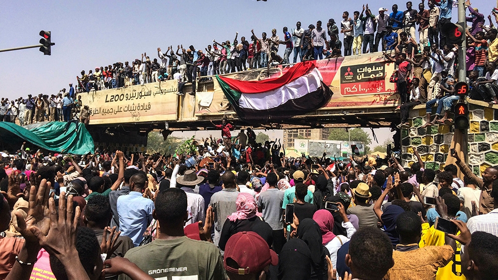Protesters rally at a demonstration near the military headquarters, Tuesday, April 9, 2019, in the capital Khartoum, Sudan. Activists behind anti-government protests in Sudan say security forces have