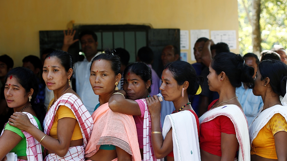 People line up to cast their votes outside a polling station in Majuli, a large river island in Assam [Adnan Abidi/Reuters]
