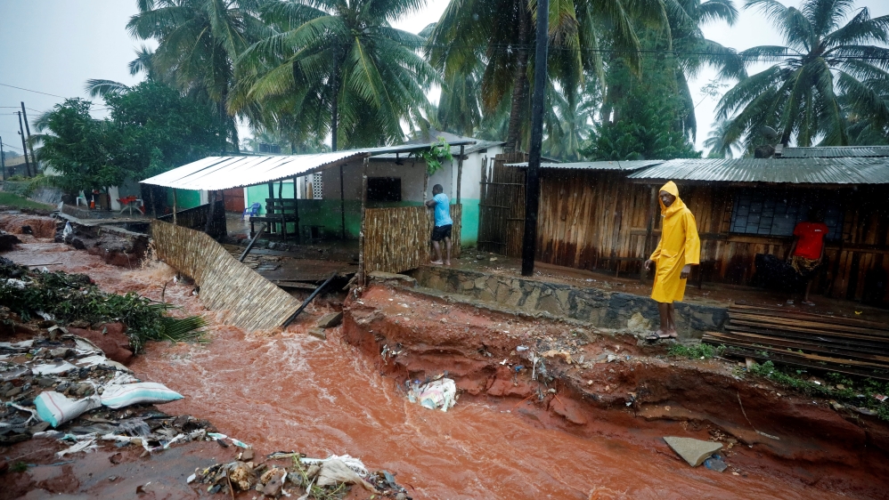 A man walks past flood damaged houses in the aftermath of Cyclone Kenneth in Pemba, Mozambique, April 28, 2019