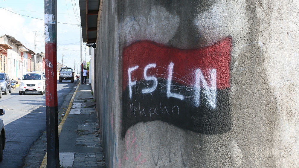 Graffiti supporting Daniel Ortega's Sandinista National Liberation Front party is painted on a wall in the city of Jinotepe, Nicaragua, where protesters faced arrest and violence in last year's crackdown on dissent [Chris Kenning/Al Jazeera] 