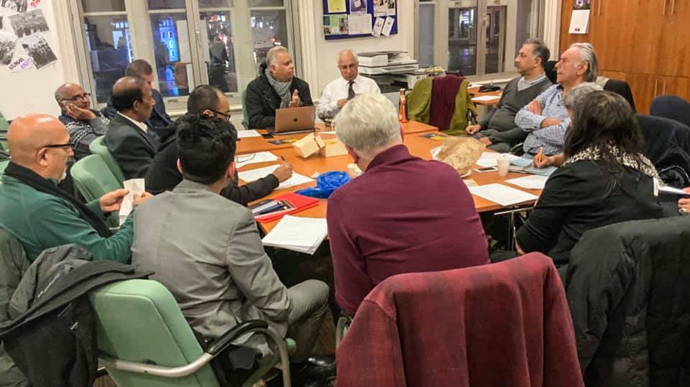 Suresh Grover (centre with laptop) and other members of the Southall Resists 40 campaign group prepare for the 40th anniversary commemorations. [Courtesy: Monitoring Group]