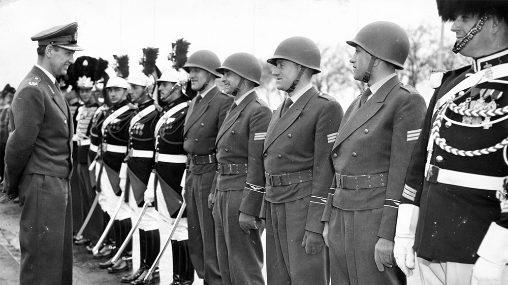 Brigadier General Earl Johann Adolf von Kielmansegg inspects April 5, 1956 the four German airforce soldiers who were stationed at the NATO Headquarters in Paris, France [Str/AP Photo]