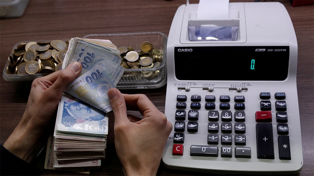 A merchant counts Turkish lira banknotes at the Grand.