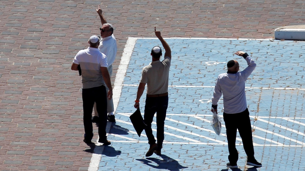 Israelis look on as the anti-missile system intercepts rockets over Ashkelon [Amir Cohen/Reuters]