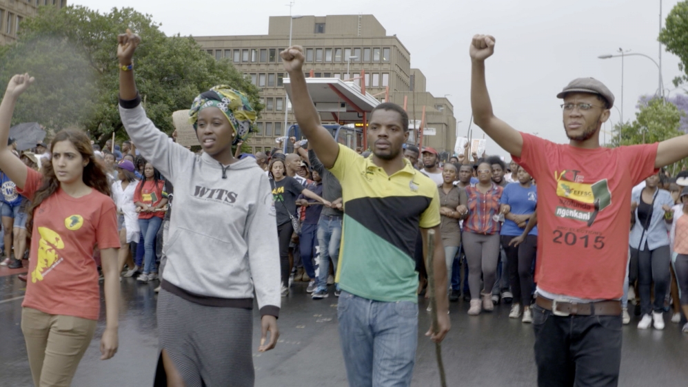 
Student leaders Shaeera Khalla, Nompandulo Mkhatshwa, Vuyani Pambo and Mcebo Dlamini and other protesters call for more fair and accessible education in 2015 [Screengrab/Al Jazeera]
