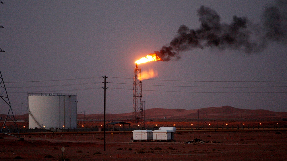 An image showing a gas flame behind pipelines in the desert at Khurais oil field, about 160 km from Riyadh, Kingdom of Saudi Arabia, 23 June 2008 (reissued 14 May 2019). Reports on 14 May 2019 state S