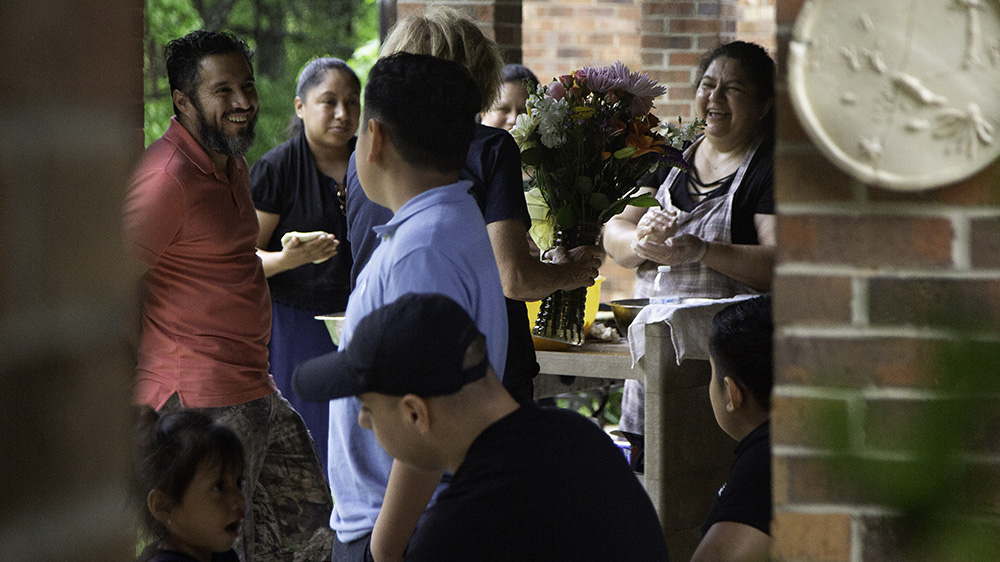 Juana is surrounded by friends and family at the church - congregants also stay with Juana in shifts when her family can't be there [Bridgette Cyr/Al Jazeera]