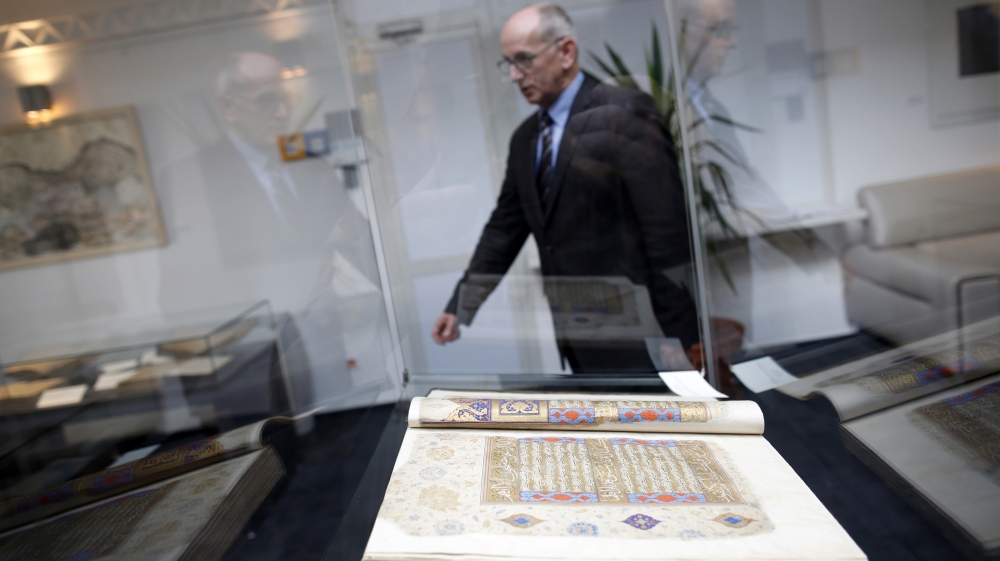 Jahic, director of Gazi Husrev-bey library walks past an old book displayed in Sarajevo