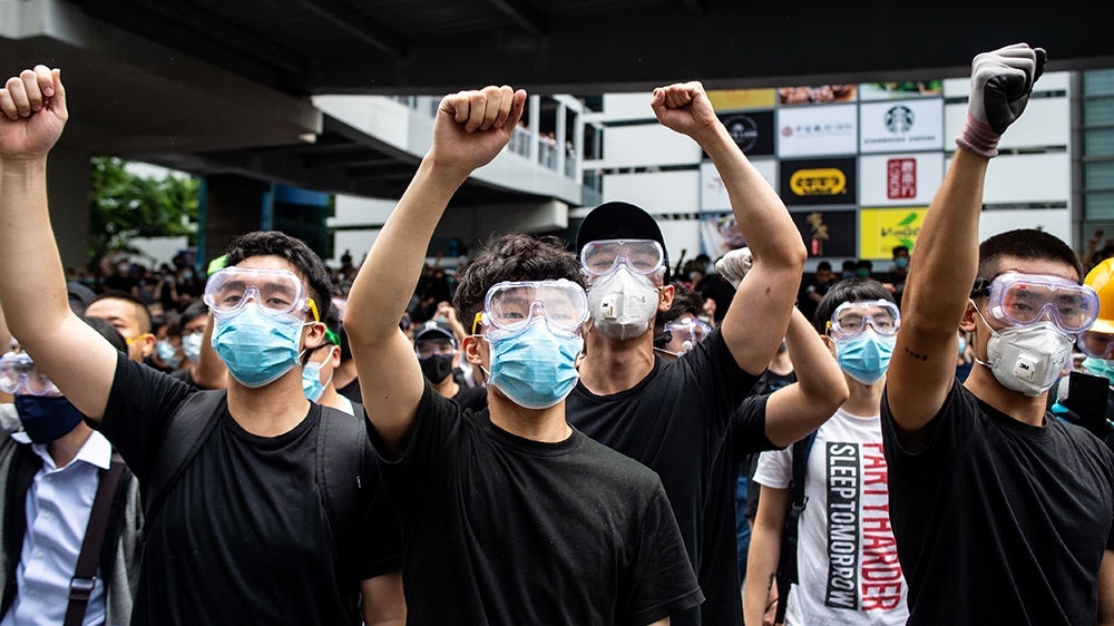 Protesters in masks and goggles chant slogans outside the Legislative Council in Hong Kong on June 12, 2019. - Hong Kong authorities delayed the second reading of a controversial bill allowing extradi