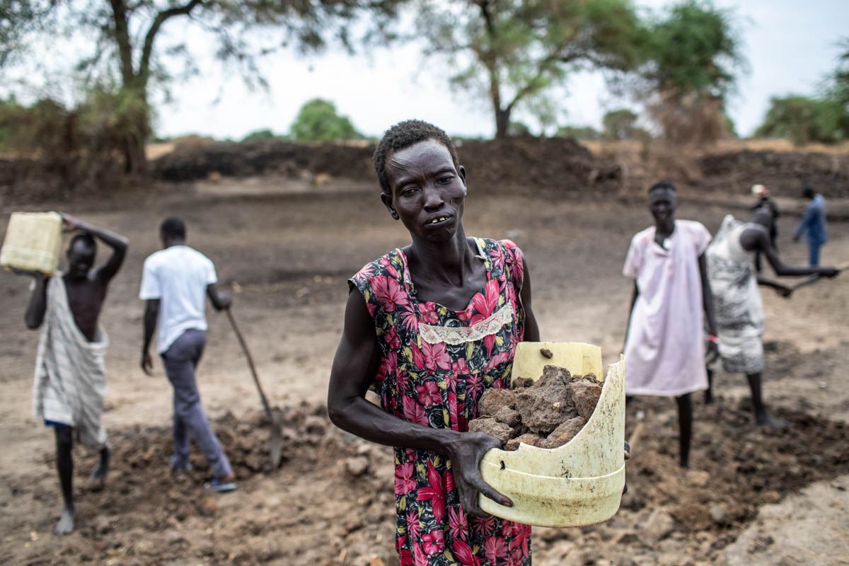Villagers work to rehabilitate a dry season pond through a food-for-assets initiative funded by the U. S. Agency for International Development’s Office of Food for Peace and implemented by Catholic Re