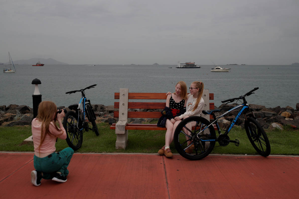 Aydili Gonzalez (L), 23, takes pictures of her sisters Ceily (C), 19 Yaili (R), 23, at the Causeway Islands, in Panama City, Panama, 22 June 2019. The indigenous Guna people, one of seven ethnic group