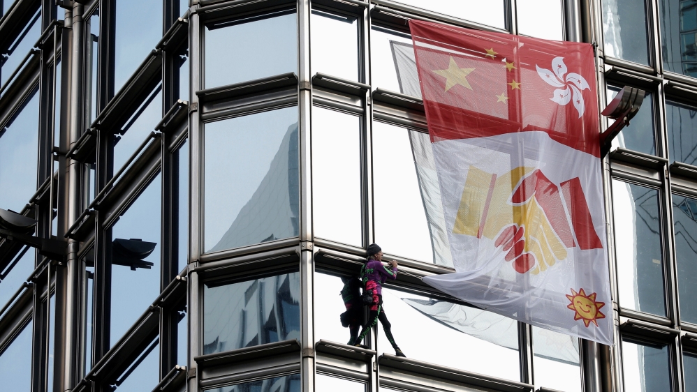 French urban climber Alain Robert climbs the Cheung Kong Center building in Hong Kong, China, August 16, 2019