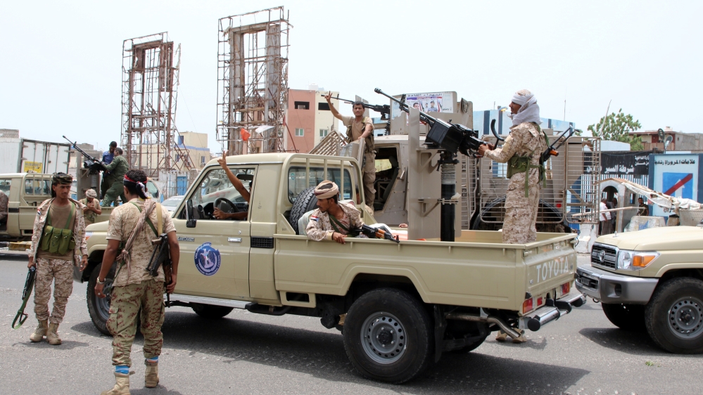 Members of UAE-backed southern Yemeni separatist forces patrol a road during clashes with government forces in Aden, Yemen