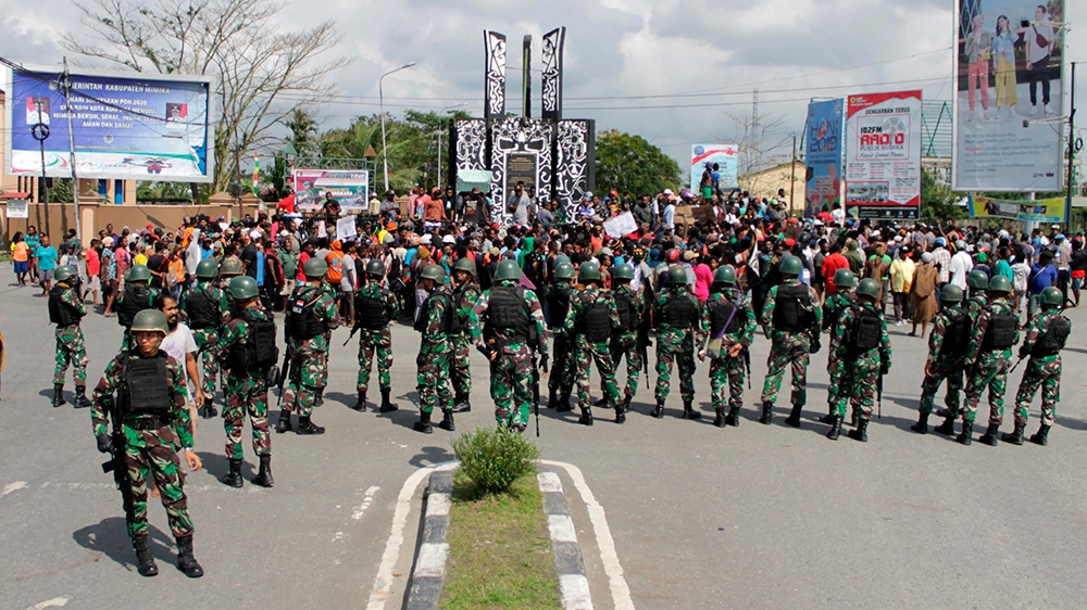Indonesian soldiers stand guard during a protest in Timika, Papua province, Wednesday, Aug. 21, 2019. Indonesia has deployed over 1,000 security personnel to the restive province of West Papua amid sp