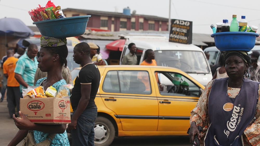 Women sells snacks and water at Ojota bus terminal in Lagos, Nigeria, Friday, Nov. 25, 2011. (AP Photo/Sunday Alamba)