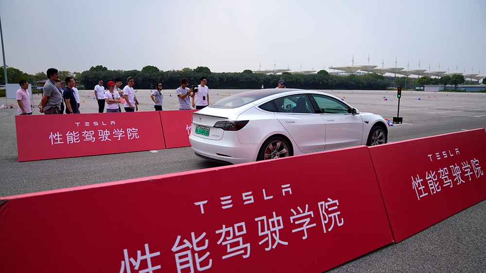 People attend a Tesla performance driving school event at Shanghai International Circuit in Shanghai, China, August 22, 2019. Picture taken August 22, 2019