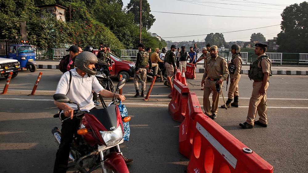 For Opinions - Indian security personnel stop people during restrictions in Srinagar, August 5, 2019. REUTERS/Danish Ismail