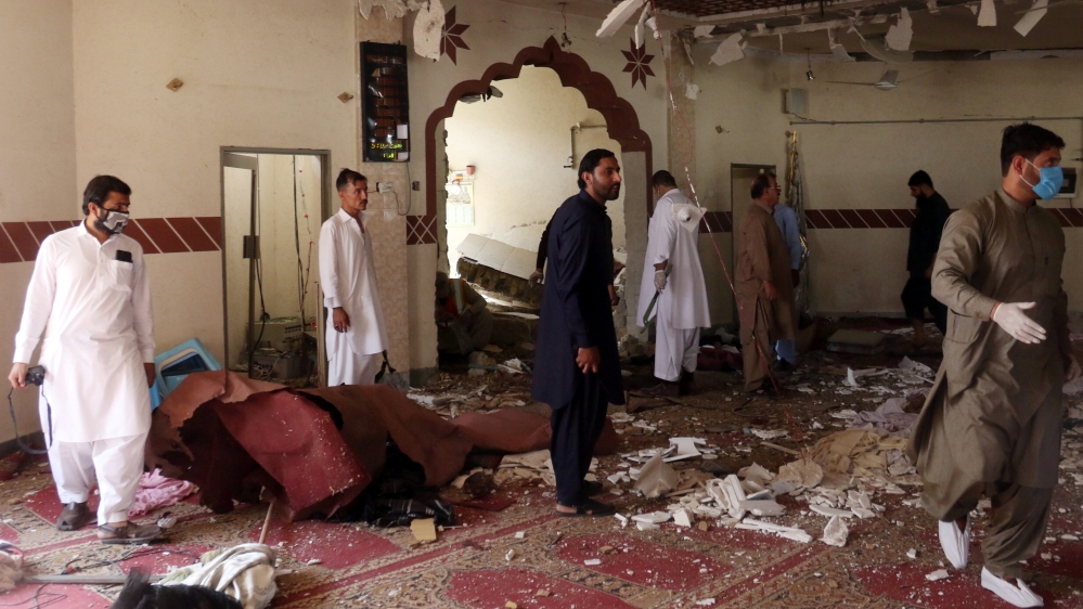 Members of a bomb disposal unit survey the site after a blast at a mosque in Kuchlak, in the outskirts of Quetta