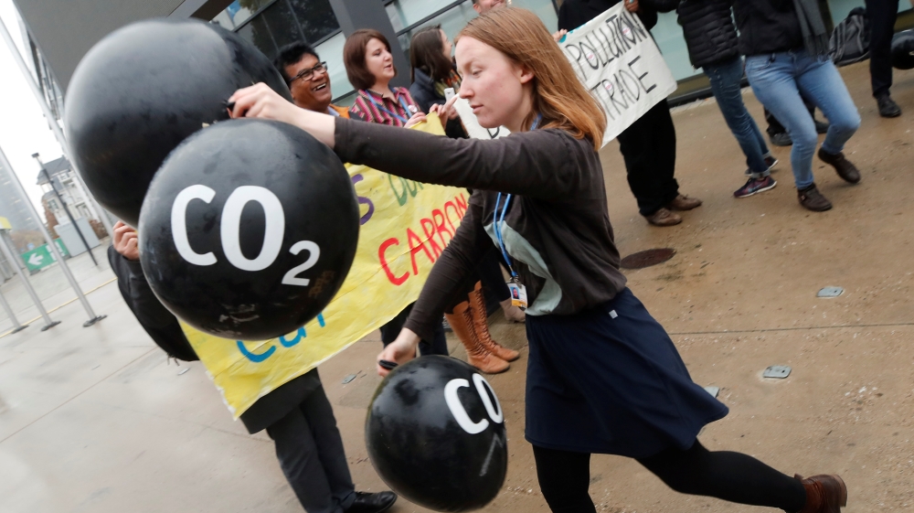 Activists protest against the carbon dioxide emissions trading in front of the World Congress Centre Bonn, the site of the COP23 U.N. Climate Change Conference, in Bonn