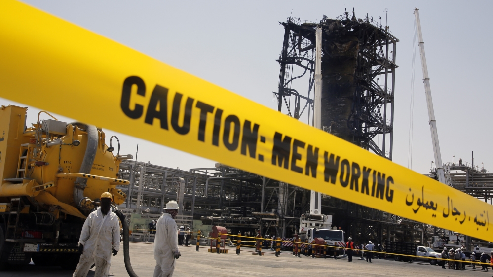 In this photo opportunity during a trip organized by Saudi information ministry, workers work in front of the recent attack Aramco''s oil processing facility in Khurais, near Dammam